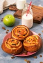Buns with raisins and milk. Breakfast with fresh pastries. Royalty Free Stock Photo