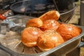 Buns with sesame seeds for burgers, cheeseburgers, hamburgers on the background of a grill for frying meat in a street cafe. Royalty Free Stock Photo