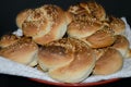 Buns with sesame seeds on a napkin and a red plate Royalty Free Stock Photo