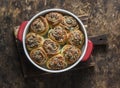 Buns stuffed with herbs and soft cream cheese on a wooden background, top view. Snack, appetizer rolls