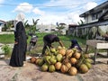 Buntok, Indonesia. March 27, 2023. The coconut seller is peeling coconuts ordered by a buyer.