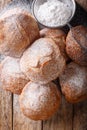 Bunuelos Mexican fritters sprinkled with powdered sugar close-up. Vertical top view