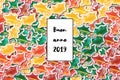 Buon anno 2019 card Happy New Year in italian with colored holly leaves as a background