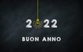 Buon Anno. Happy New Year 2022 in Italic chalkboard Creative Concept. 2022 Light Bulb On Blackboard with Italy Words