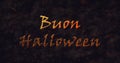 Buon Halloween text in Italian dissolving into dust to bottom