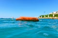 Buoy on the beach of the Aegean Sea. The concept of active recreation and rescue on the water. Selective focus. Royalty Free Stock Photo