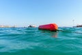 Buoy on the beach of the Aegean Sea. Selective focus. There is a place for your text. The concept of active recreation. Royalty Free Stock Photo
