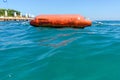 Buoy on the beach of the Aegean Sea. Selective focus. There is a place for your text. The concept of active recreation. Royalty Free Stock Photo