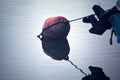 Buoy floating on the water and its reflection casted below it Royalty Free Stock Photo