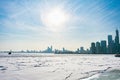 A Buoy in a Frozen Lake Michigan in Chicago with the sun and skyline after a Polar Vortex