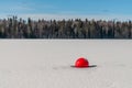 A buoy frozen in the lake`s ice