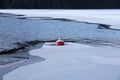 Buoy in the water. Some parts of the water is already frozen. Royalty Free Stock Photo