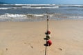 Buoys on a rope leading into the ocean Royalty Free Stock Photo