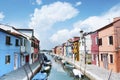 Burano island, Italy - beautiful view of a street with colorful houses and canal. Venice postcard Royalty Free Stock Photo