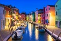 Burano island at night, Venice, Venetian Lagoon, Italy. Colourfully painted houses facades along the small beautiful canal with