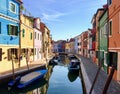 A beautiful view of the famous canals and colourful homes of the island town of Burano, Italy on a beautiful morning.