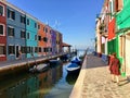 A young female tourist by herself exploring the beautiful view of the famous canals and colourful homes