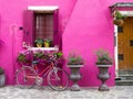 Burano, Italy - 21 May 2015: Painted building with bicycle