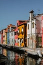 Burano island canal, colorful houses and boats, Venice, Italy