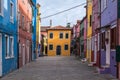 Street of brightly coloured houses on the island of Burano, Venice. Photograph taken on a sunny day.
