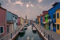 Burano street with colorful houses and water channel with boats