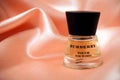 Burberry perfume in a transparent bottle on satin background