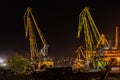 Burgas, Bulgaria - August 26, 2015 21:29h : Cargo cranes on the coast of Fish port of Burgas, Bulgaria Royalty Free Stock Photo