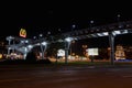 BURGAS, BULGARIA - FEBRUARY 1, 2018: Overhead pedestrian bridge at night. McDonald`s restaurant logo