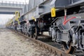 Burgas, Bulgaria - January 24, 2017. Freight cargo train - black cars wagons. New 6-axled flat wagon ,Type: Sahmmn, Model WW 6