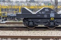 Burgas, Bulgaria - January 24, 2017. Freight cargo train - black cars wagons. New 6-axled flat wagon ,Type: Sahmmn, Model WW 6