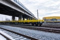 Burgas, Bulgaria - January 27, 2017 - Freight cargo train - yellow black New 4-axled flat cars wagons Type:Res Model:072-2- Transv