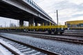 Burgas, Bulgaria - January 27, 2017 - Freight cargo train - yellow black New 4-axled flat cars wagons Type:Res Model:072-2- Transv