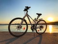 Blue and white bicycle of the HEAD company parked near the sea. Sarafovo fishing port near Burgas, Bulgaria at sunset.