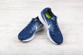 BURGAS, BULGARIA - SEPTEMBER 6, 2017: Nike Air Zoom Pegasus 34 Women`s Running Shoes in blue on white wooden background.