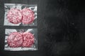 Burger beef veal cutlets in vacuum plastic, on black stone background, top view flat lay, with copy space for text Royalty Free Stock Photo