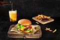 Burger and beer. Hamburger with beef, cheese, onion, tomato, and green salad Royalty Free Stock Photo