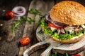 Burger with blue cheese and arugula on rustic wooden background. fast food and junk food concept Royalty Free Stock Photo