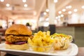 Burger, a bowl of french fries and salad on a plate