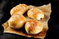 Burger Buns on a Paper Served on Black Table Royalty Free Stock Photo