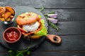 Burger with camembert cheese and meat. French fries and ketchup. Top view, Royalty Free Stock Photo