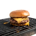 A burger with cheddar cheese on a grill, isolated Royalty Free Stock Photo
