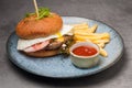 Burger with chicken cutlet and egg with french fries and ketchup Royalty Free Stock Photo