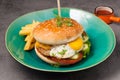 Burger with chicken cutlet and egg. With tomato sauce and French fries Royalty Free Stock Photo