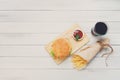 Burger, chips and cola at white wood Royalty Free Stock Photo