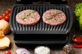 Burger cutlets are fried on a smart electric grill, homemade burgers