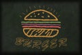 Burger drawn with chalk on a chalkboard with a text