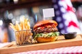 Burger with empty food flag and french fries in american restaurant