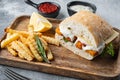 Burger with fish fingers fresh lettuce, tomato and tartar sauce, on gray background Royalty Free Stock Photo