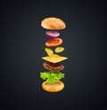 Burger with flying ingredients on black background. Delicious hamburger in the air. Royalty Free Stock Photo