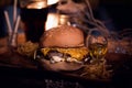 Burger food photo. Street food. Fresh tasty grilled beef hamburger cooked at barbecue on wooden table. Big cheeseburger